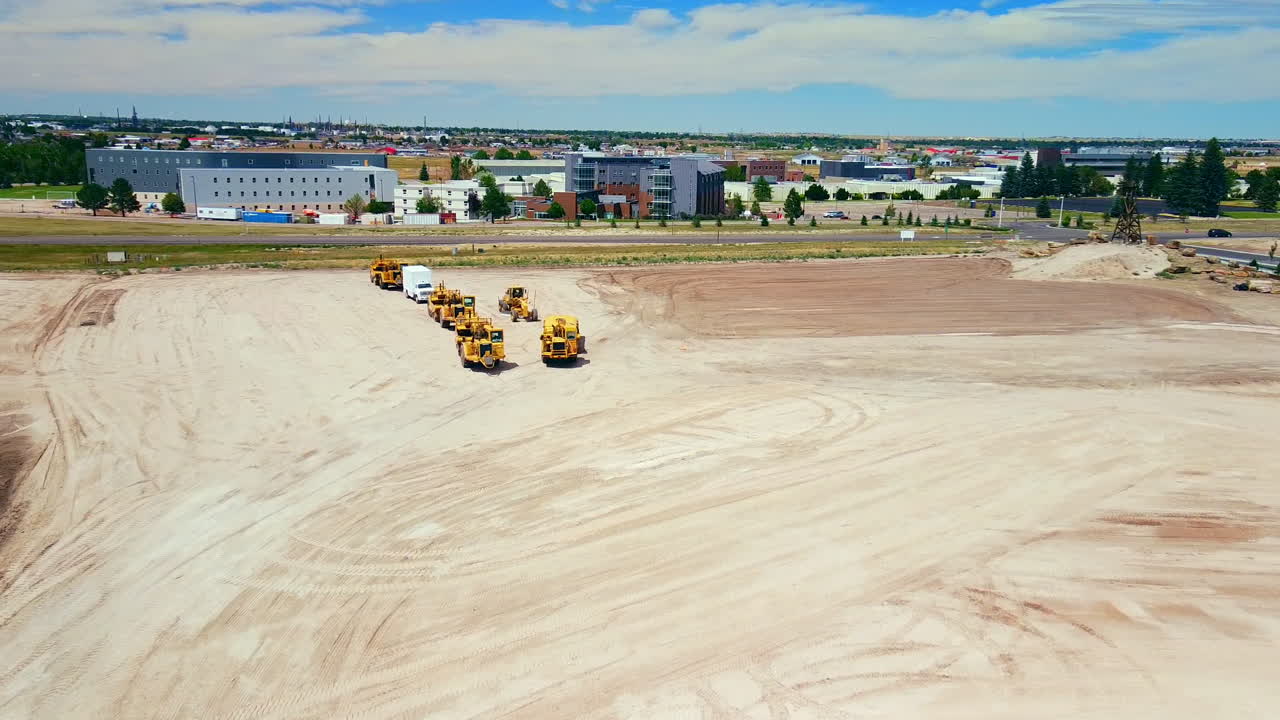 Fly over construction equipment on empty subdivision lot