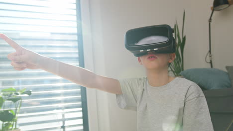 boy experiencing virtual world by using virtual reality headset, medium shot