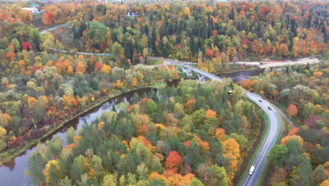 aerial view of the sigulda bridge and cable car over gauja river during golden autumn season in latvia