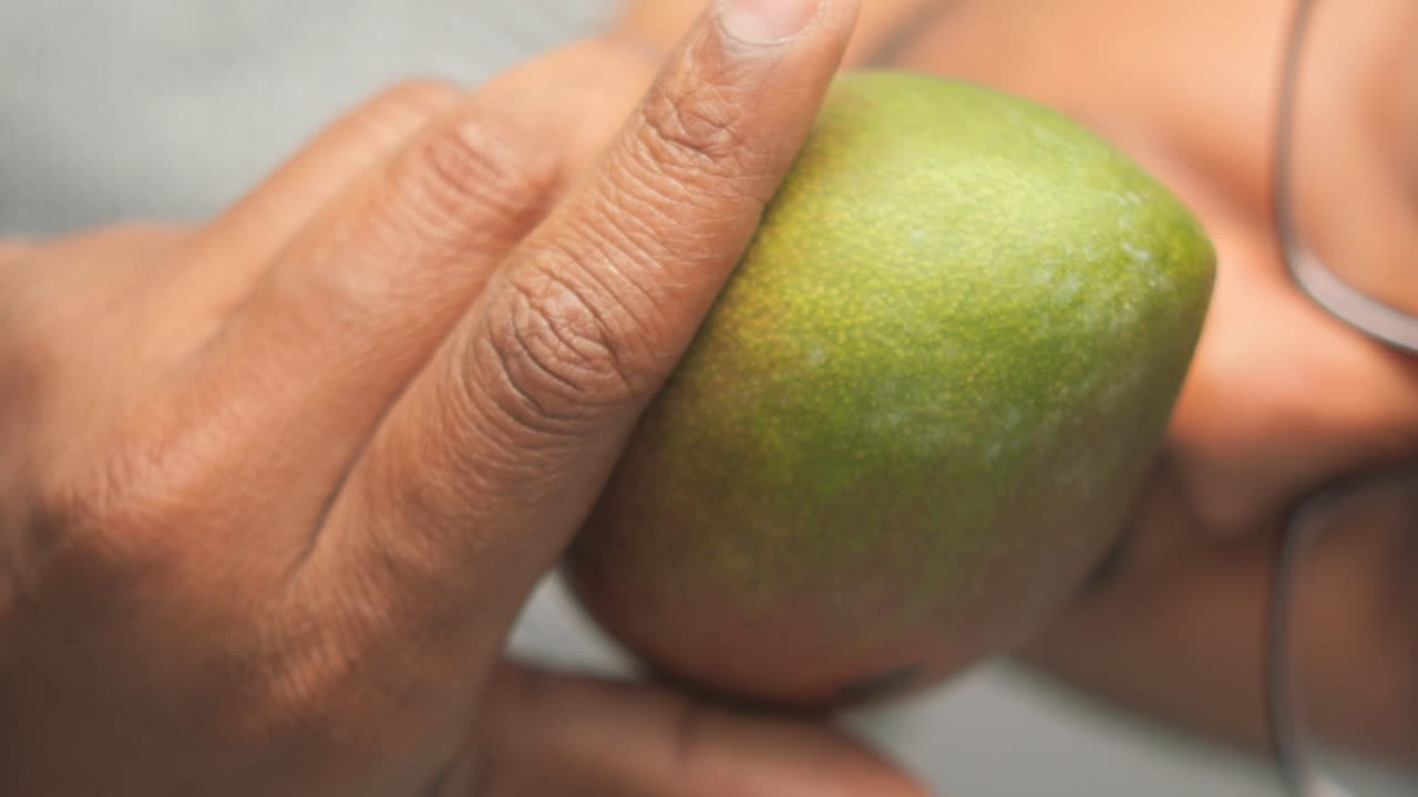 Person eating a mango