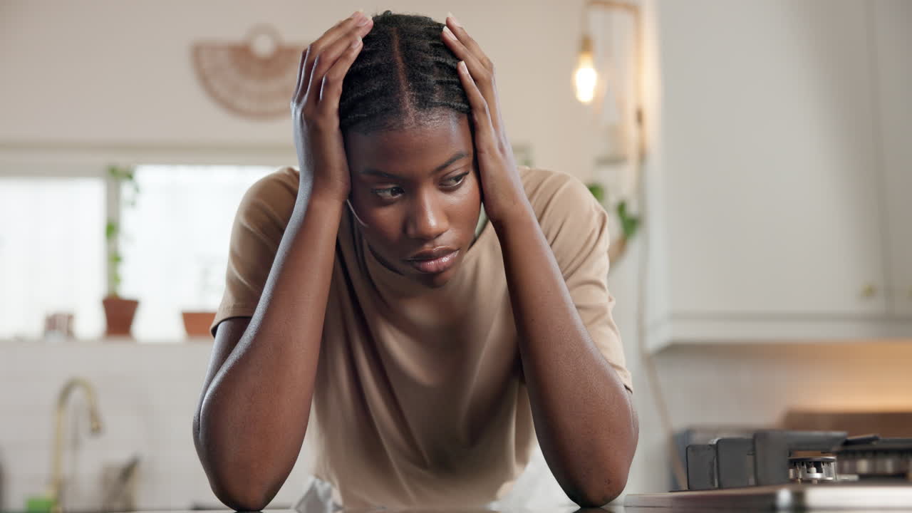 Sad Woman with Headache in Kitchen