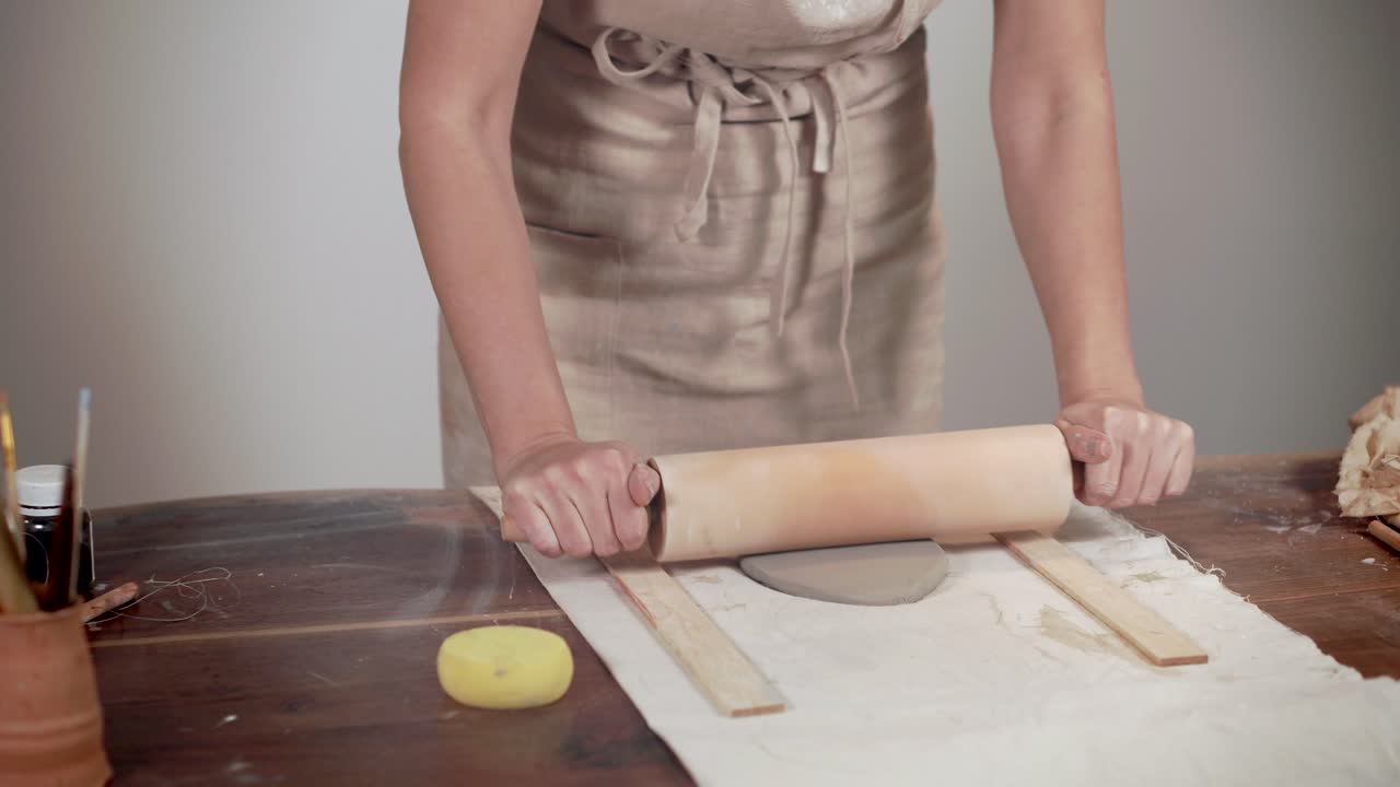 Woman Shaping Clay Plate