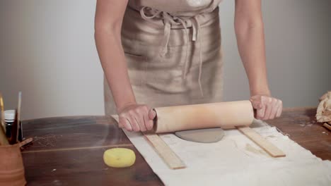 woman shaping clay plate