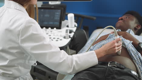doctor performing abdominal ultrasound on a patient