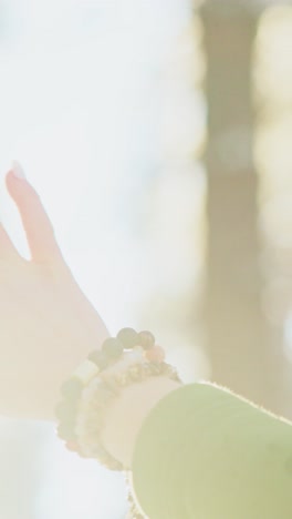 woman's hand with bracelet in nature