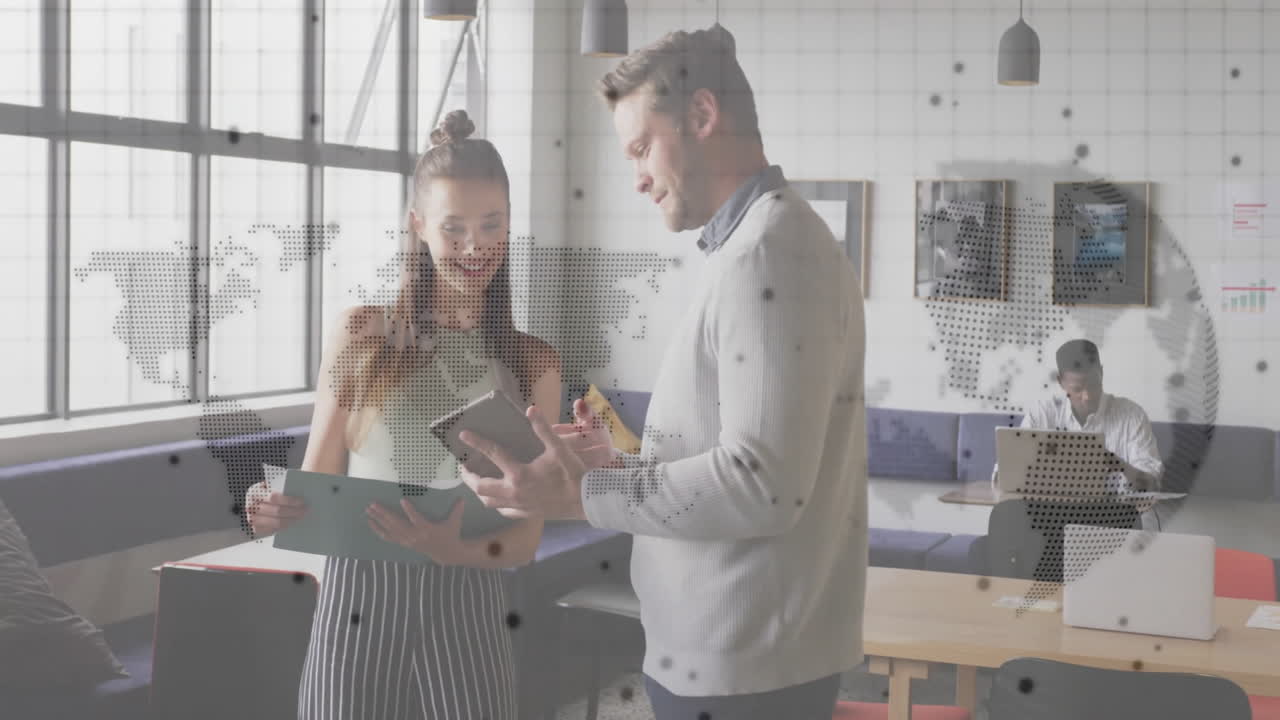 Discussing documents, business professionals with animated world map overlay in office