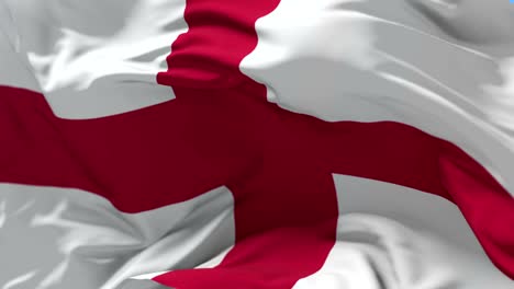 flag of england waving at wind in blue sky, loop