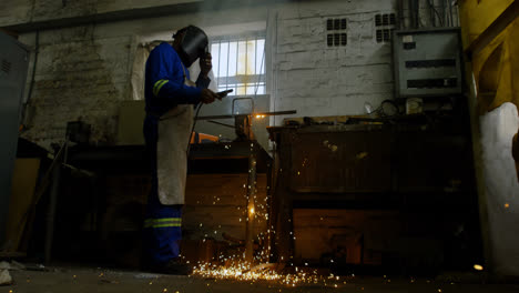 metalsmith using welding torch in workshop 4k