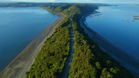 aerial shot of lemuy island showcasing the narrow land strip with ocean on both sides at sunset