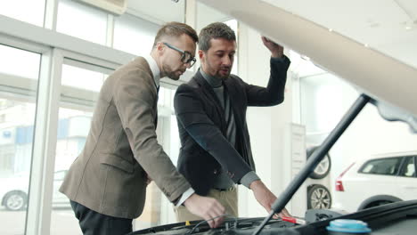 car salesmen discussing car details with customer