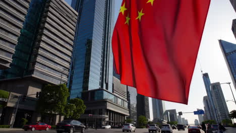 chinese flag flying above skyscrapers in a city