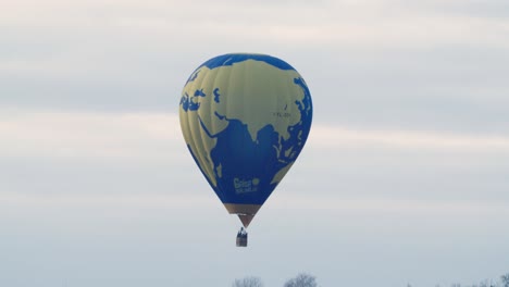 hot air balloon low flight over autumn fall trees