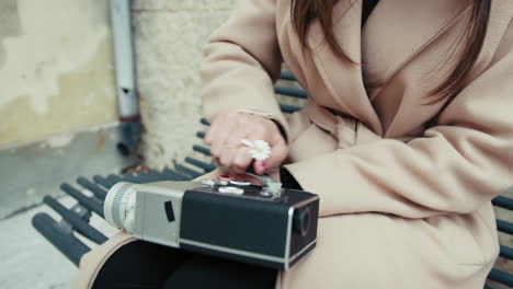woman preparing the analog camera for shooting close up