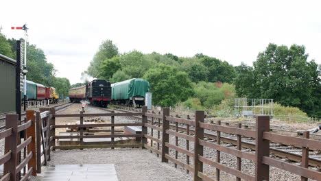 steam engine train approaching platform at a railway station