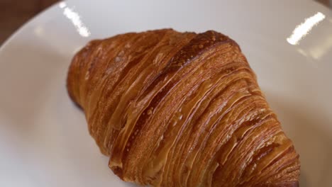 a perfect fresh baked flaky butter croissant, slider close up 4k