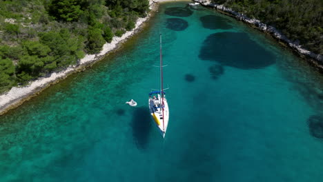 tourists on boat relaxing in the lagoon in pakleni islands, croatia. - aerial shot