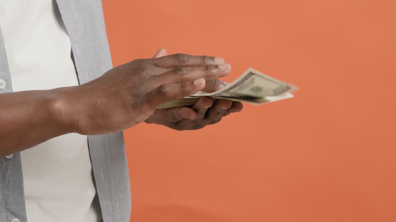 Persona che maneggia una pila di dollari statunitensi