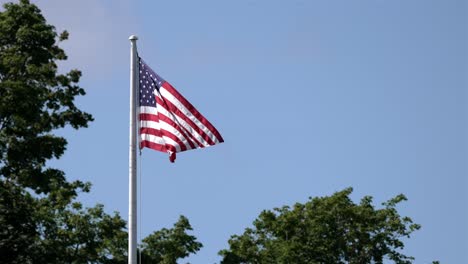 american flag with red white and blue colors wave in wind, pan across