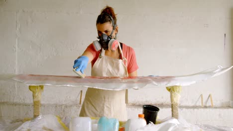 woman making surfboard 4k