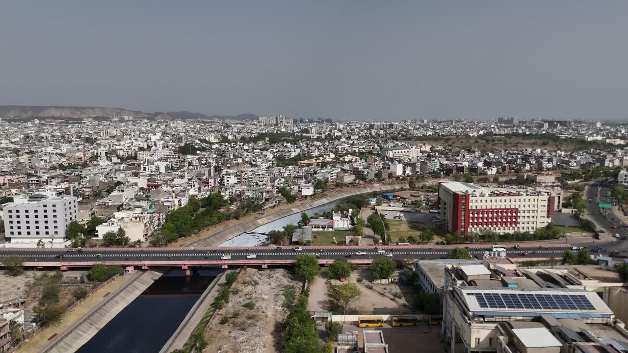 Jaipur city growth illustrated through flyover and metro projects. Aerial shot of Jaipur city with crowded buildings