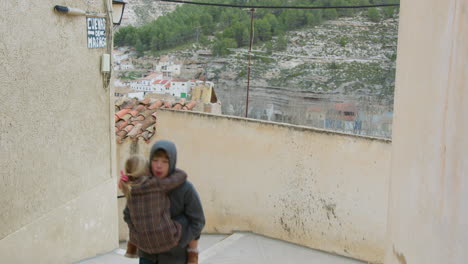 brother and sister hugging in a town