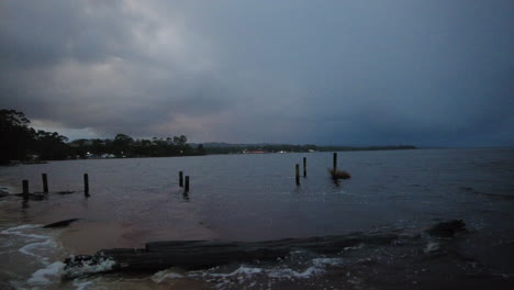 moody morning across the lake in strahan, west coast tasmania