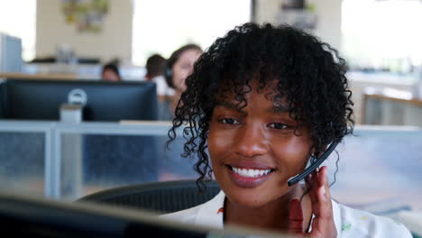 Young-black-woman-working-at-a-call-centre,-close-up