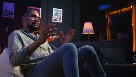 vertical video african american person smiling and chatting during a video call at home
