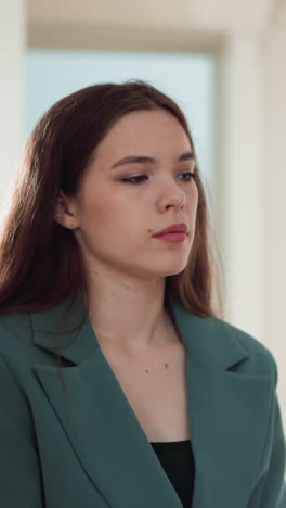 displeased woman with obsessive thoughts at home. dark haired lady expresses seasonal melancholy feelings in apartment. problematic emotional state