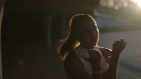 dancing woman young hispanic hip hop dancer in city enjoying fresh urban freestyle dance moves practicing expression at sunset close up