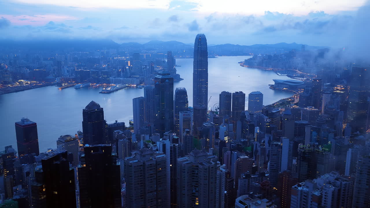 Aerial view of Hong Kong skyline at golden hour featuring IFC and ICC towers, symbolizing global finance, modern architecture, and a vibrant hub for travel and business