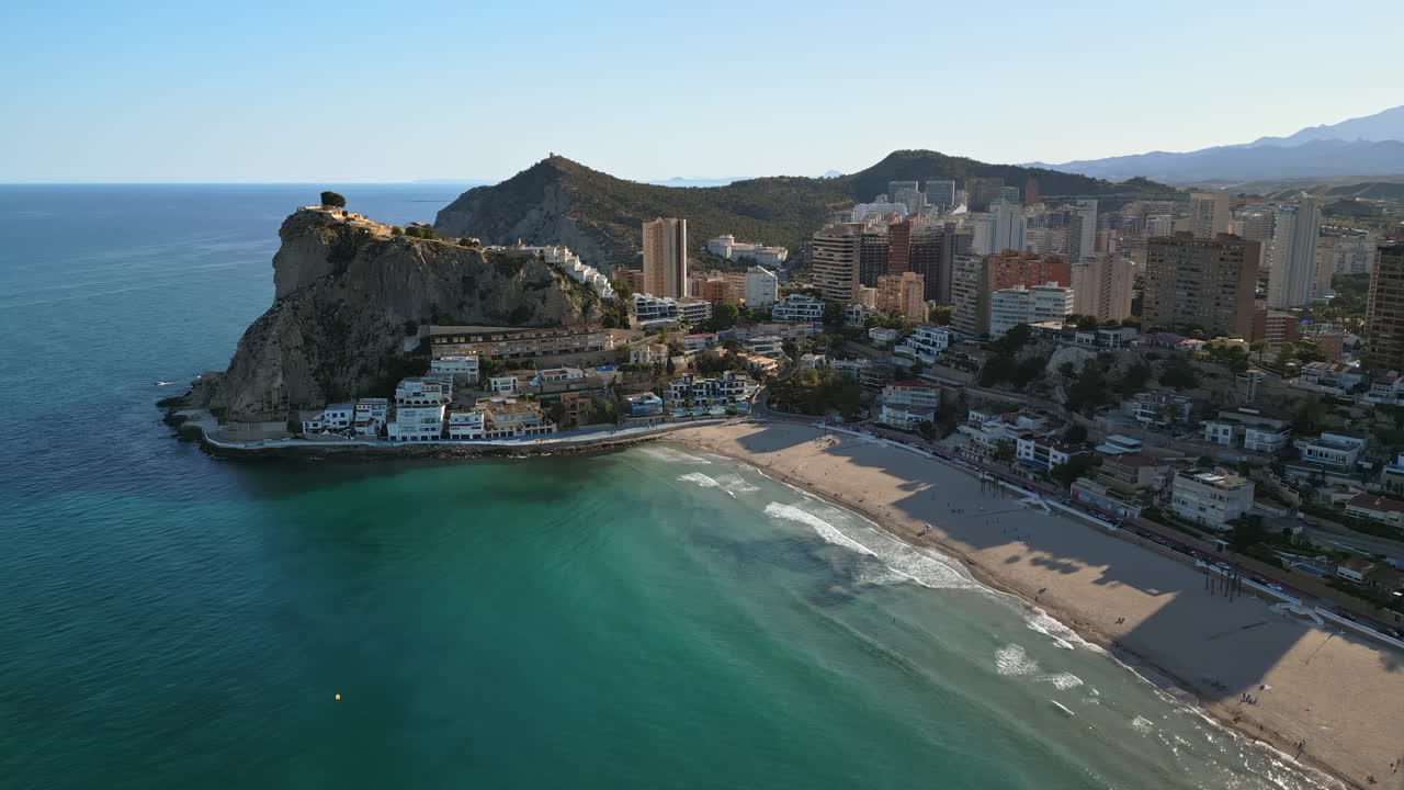 Aerial drone view of the buildings along the coastline and the sea in Benidorm, Spain in daylight