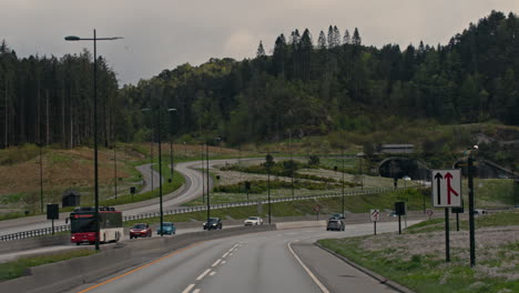 dolly shot along a highway in vestland with busy traffic coming towards the city