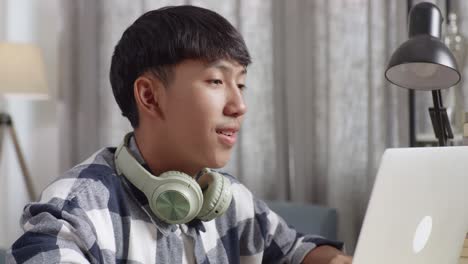 teenager studying on laptop