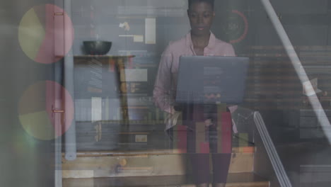 Animation-of-data-processing-over-african-american-woman-using-laptop