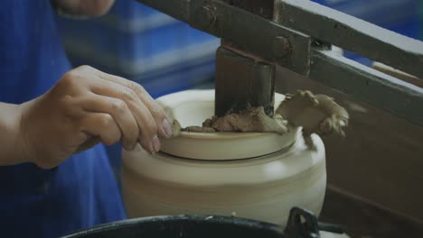 slow motion, master potter creating ceramic products from white clay