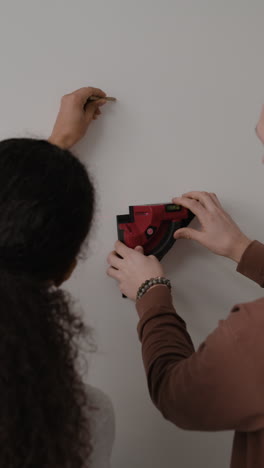 couple using laser level for home improvement project