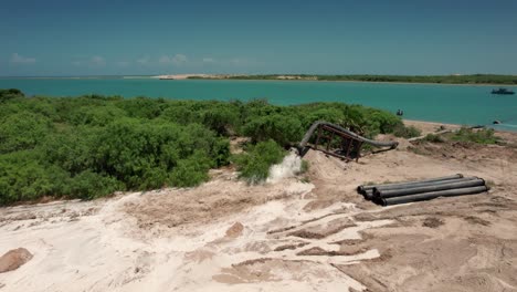 fully operational sand drainage pipe in matamoros, tamaulipas, mexico, with a backdrop of beautiful azure sea