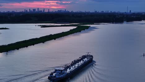 birdseye, slow motion footage of tanker sailing on the river noord, netherlands