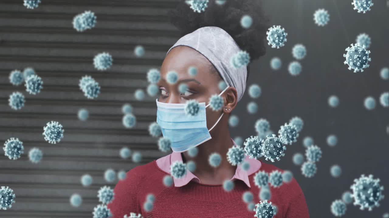 Animation of covid 19 cells over african american woman wearing face mask