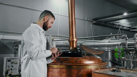 brewery worker checking equipment