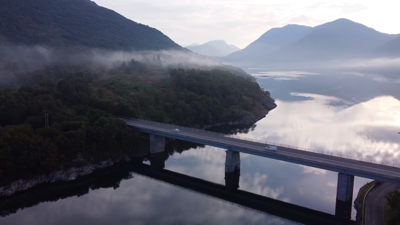 Cars Driving Over Bridge on Loch Creran Near Appin, Scotland on a Misty Morning, Aerial Drone 4K HD Footage Rising Up