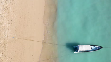 Bird-view-of-the-beautiful-beach-in-Bali-with-sailing-boat-in-frame