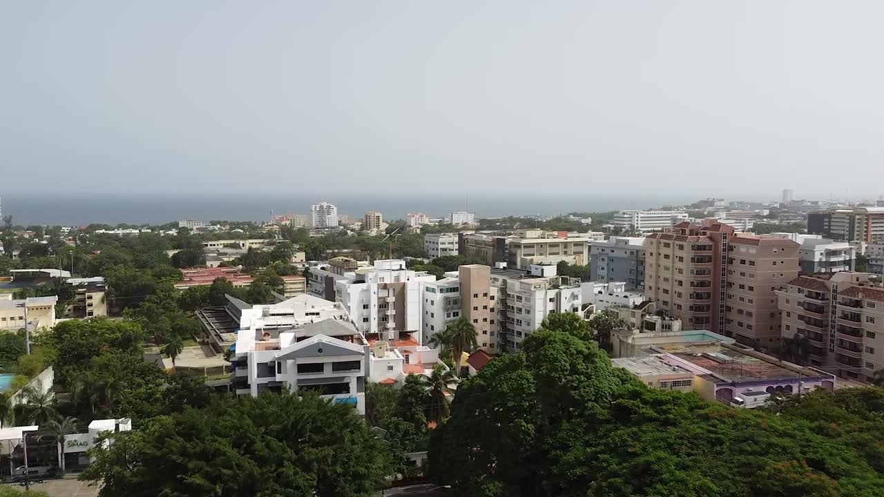 Aerial view of the iberoamerican park with the background of the city with high rise residential apartments, beautiful sunny day
