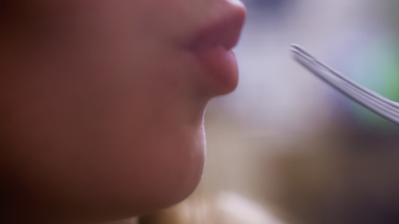 Close-up of character enjoying creamy croissant topped with whipped cream and fruit with fork in cozy cafe. Relishing dessert in warm atmosphere with focus on sweet indulgence