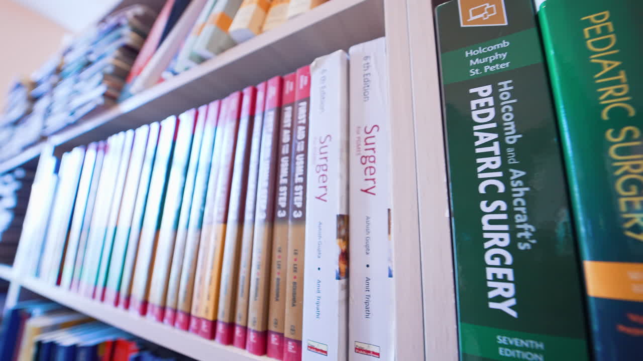 Shots of books inside university library. Bookshelves in university library with lots of books