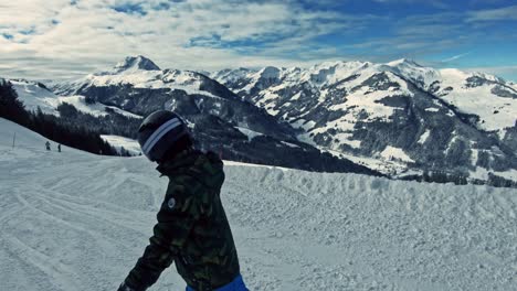 a kid snowboarding down the ski run