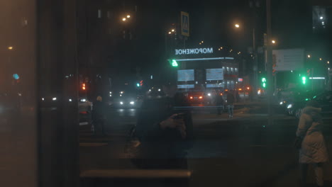 Woman-with-mobile-against-night-street-of-big-city