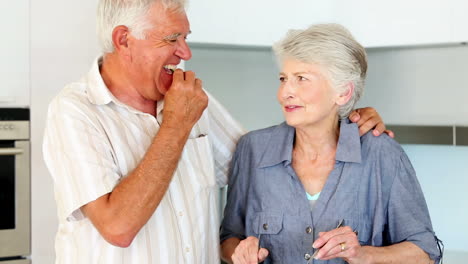 senior couple preparing a healthy salad