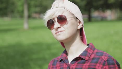 a youngster wearing transparent sunglasses protecting eyes from the bright sunlight - close up shot